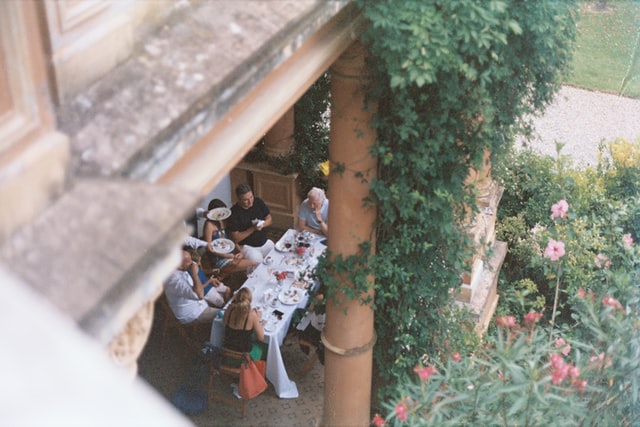 A big family having lunch and discussing ways of handling sentimental items when downsizing.